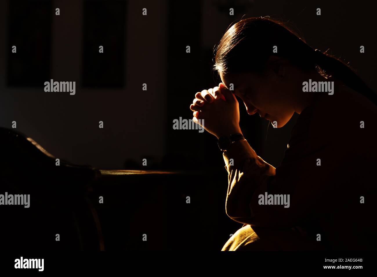 depressed women sitting in the low light church and praying, International Human Rights day concept Stock Photo