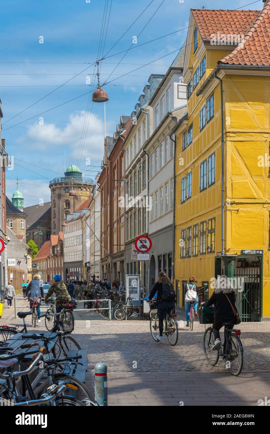 Copenhagen Old Town, view of people cycling along Krystalgade, a typical street in the old town Latin Quarter of Copenhagen, Denmark. Stock Photo