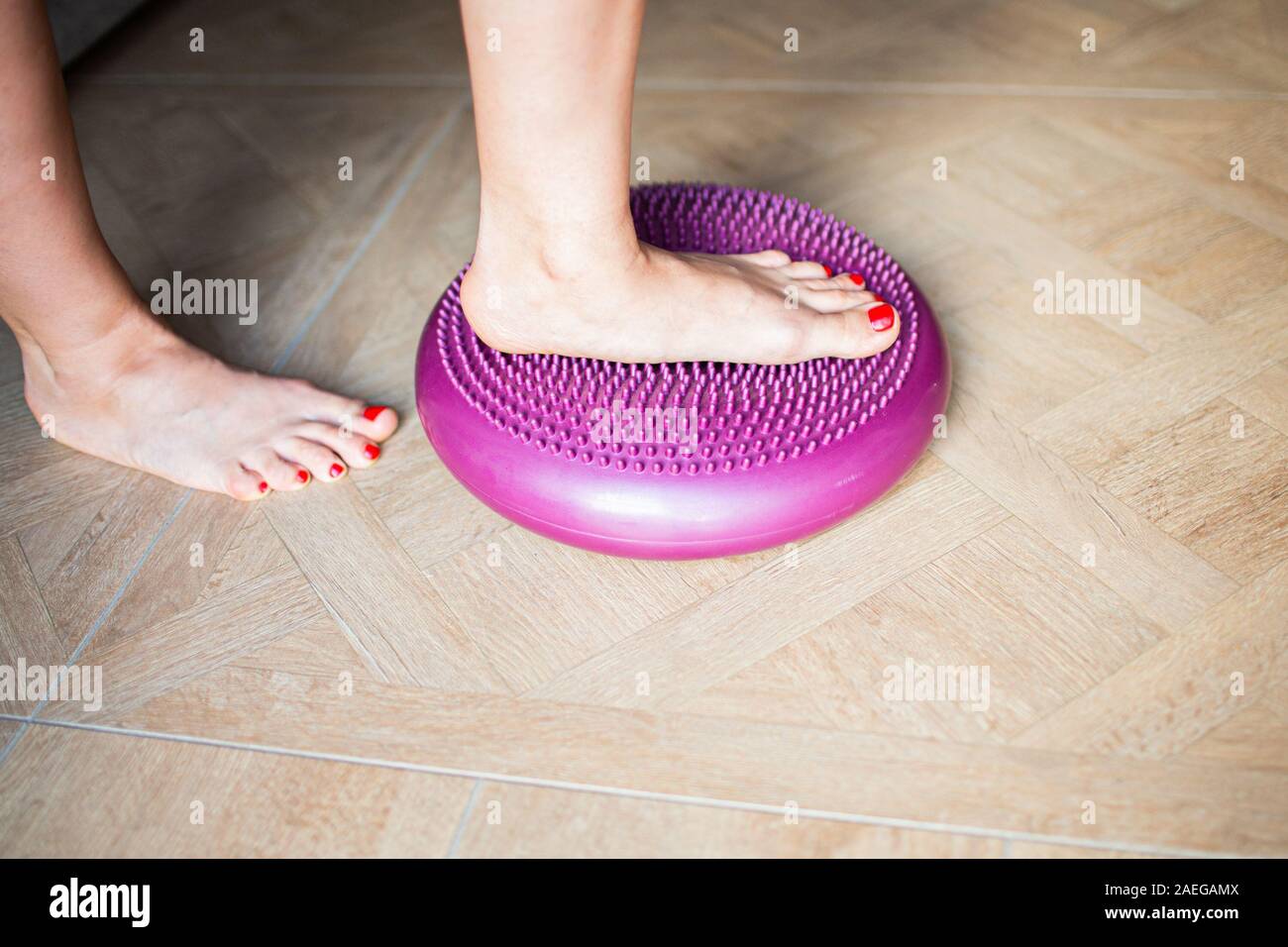 Flat Feet Correction exercises with a ball . Woman massaging her feet
