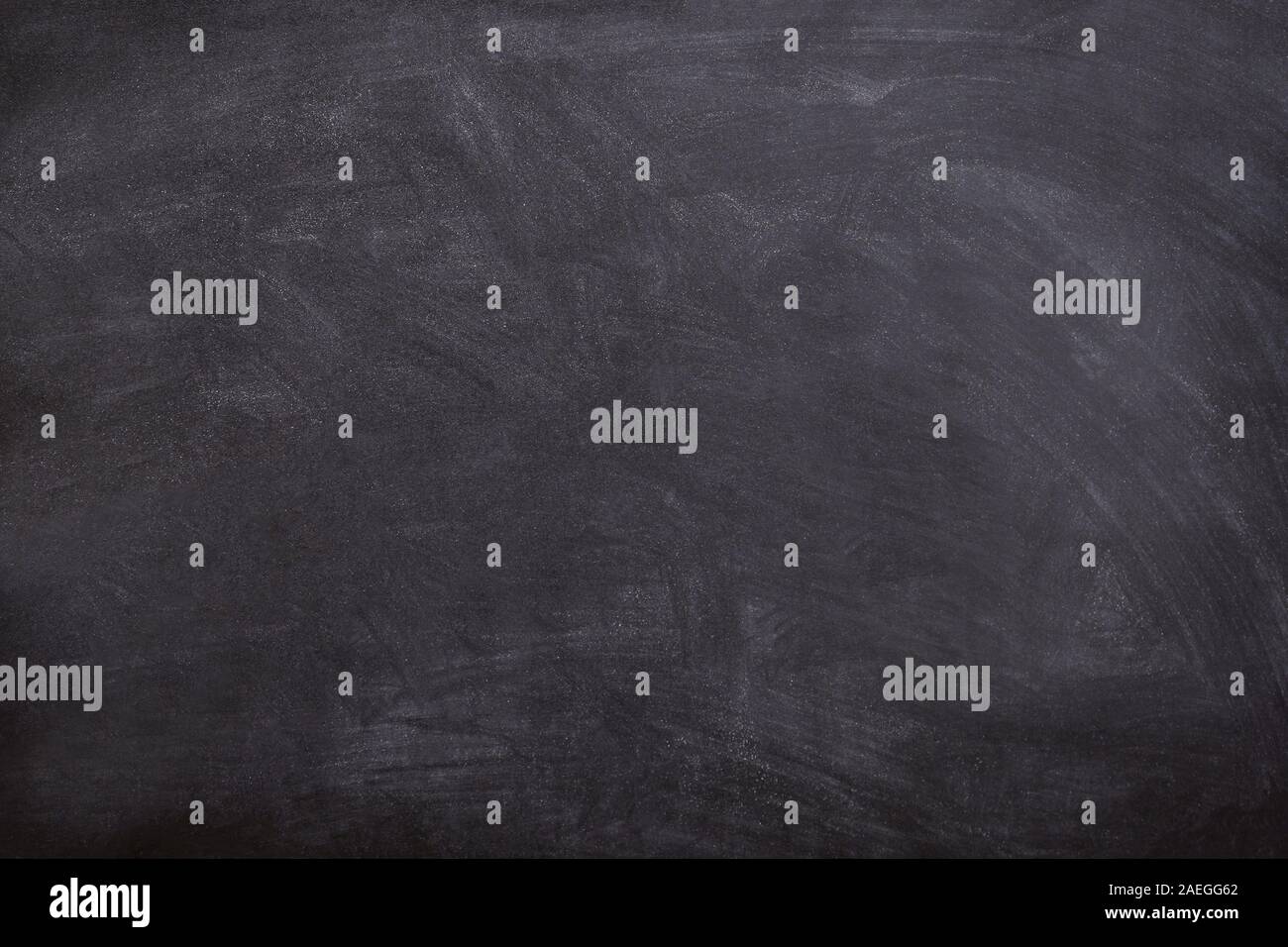 A black and white blackboard with white chalk smeared on it.Texture or