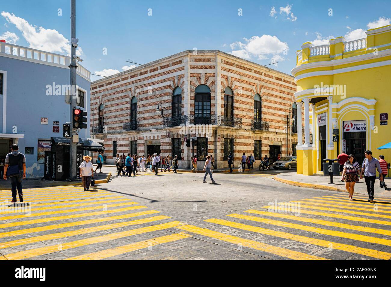 Merida, Yucatan, Mexico: people using the colourful zebra crossing surrounded by brightly painted colonial buildings in Merida city centre. Stock Photo