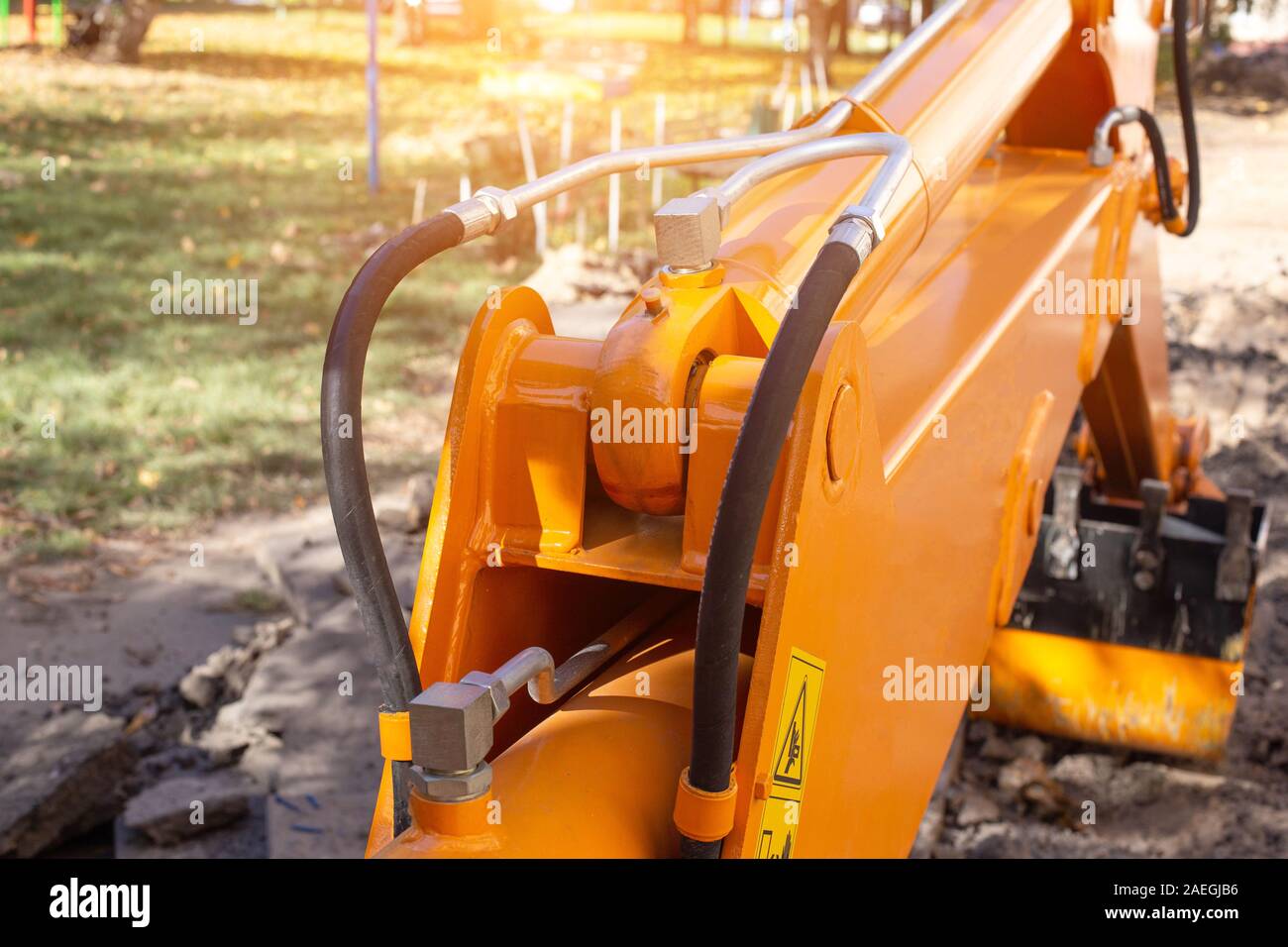 Back hydraulic excavator bucket in the courtyard of the house. The concept of repair work on water supply, pipe replacement, indusrty Stock Photo