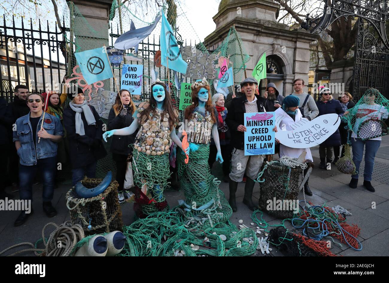 Leah Rossiter (left) and Ceara Carney, dressed as mermaids, join members of the Irish Wildlife Trust and Extinction Rebellion Ireland protesting outside Leinster House in Dublin, against overfishing in Irish Waters. Stock Photo