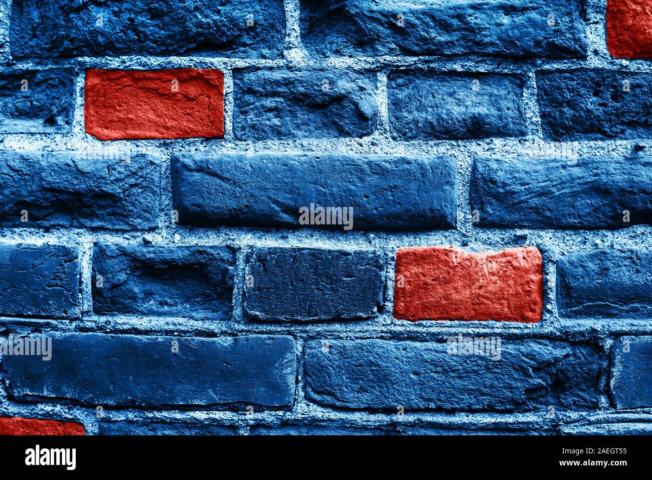 Close up image of old brick wall in blue color with some coral bricks. Background. Trendy colors of 2019 and 2020. Stock Photo
