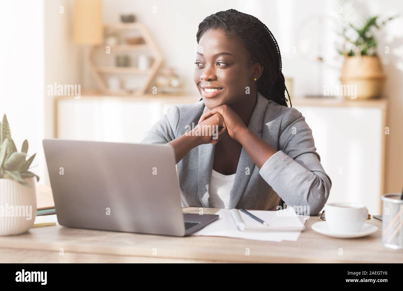 Portrait of successful black millennial female entrepreneur at workplace Stock Photo