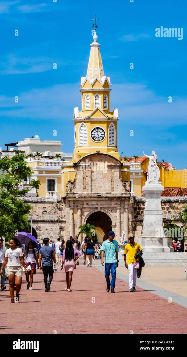 Locals walking in front of the clock tower gate which is  the main entrance into the old city of Cartagena Stock Photo