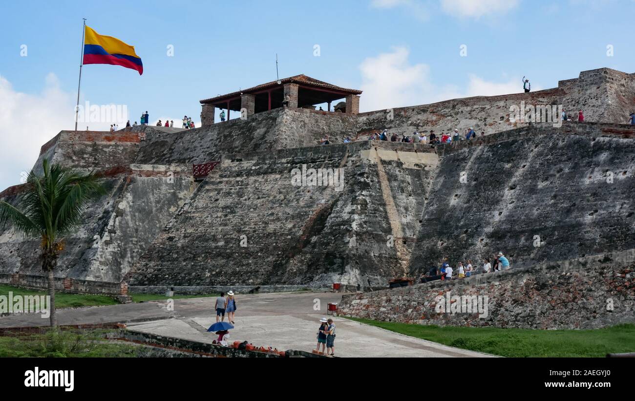 Fortress in the city of Cartagena called Castillo San Felipe de Barajas with open flag of Colombia as background Stock Photo