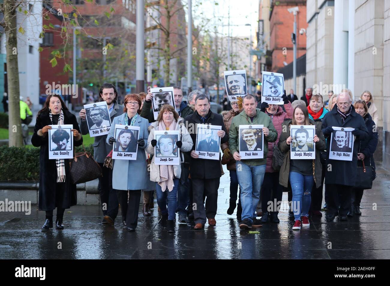 Family members outside Laganside Courts in Belfast hold images of some of those who were killed in disputed circumstances over the course of three days between August 9-August 11, 1971. Stock Photo