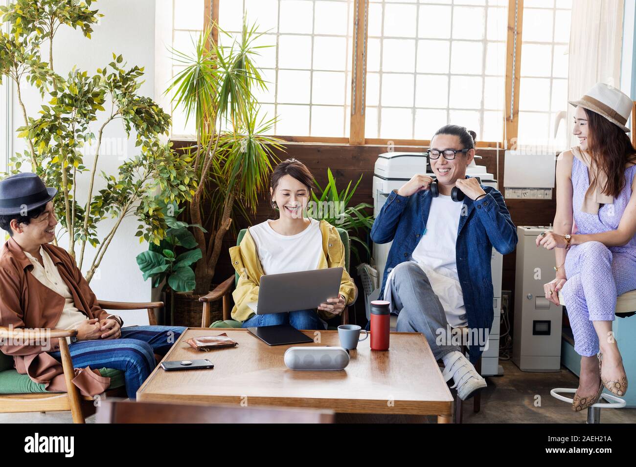 Group of young Japanese professionals working on laptop computers in a co-working space. Stock Photo