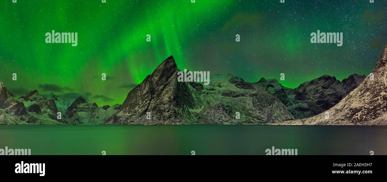 Panorama of the aurora borealis over a fjord on the Lofoten in northern ...