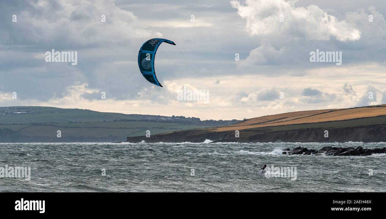 Man parasailing off the beach, Garrylucas Beach, Kinsale, County Cork, Ireland Stock Photo