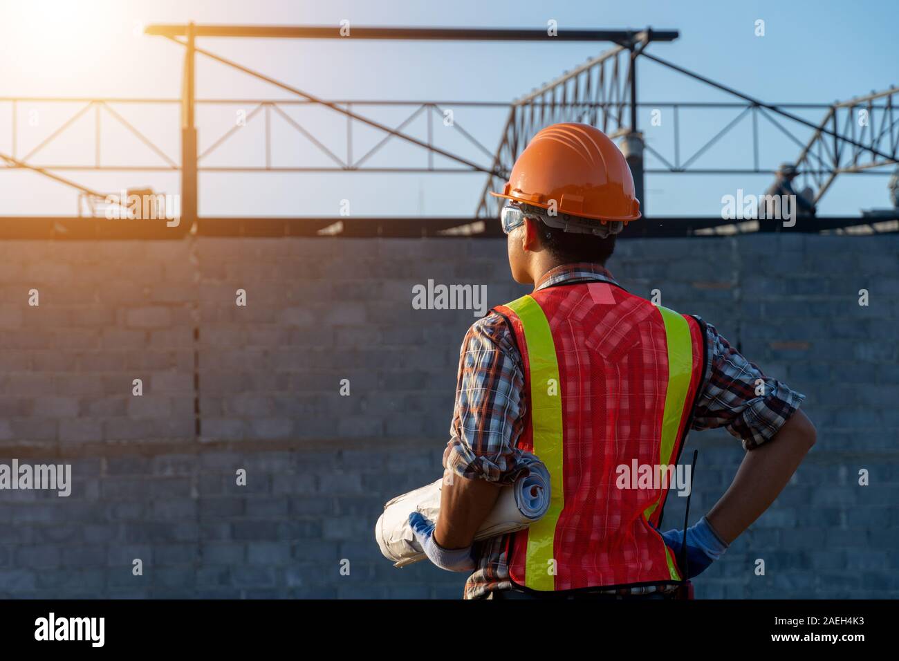 Topside Engineer Backside Engineer Asia smart handsome and holding the digital blueprint ...