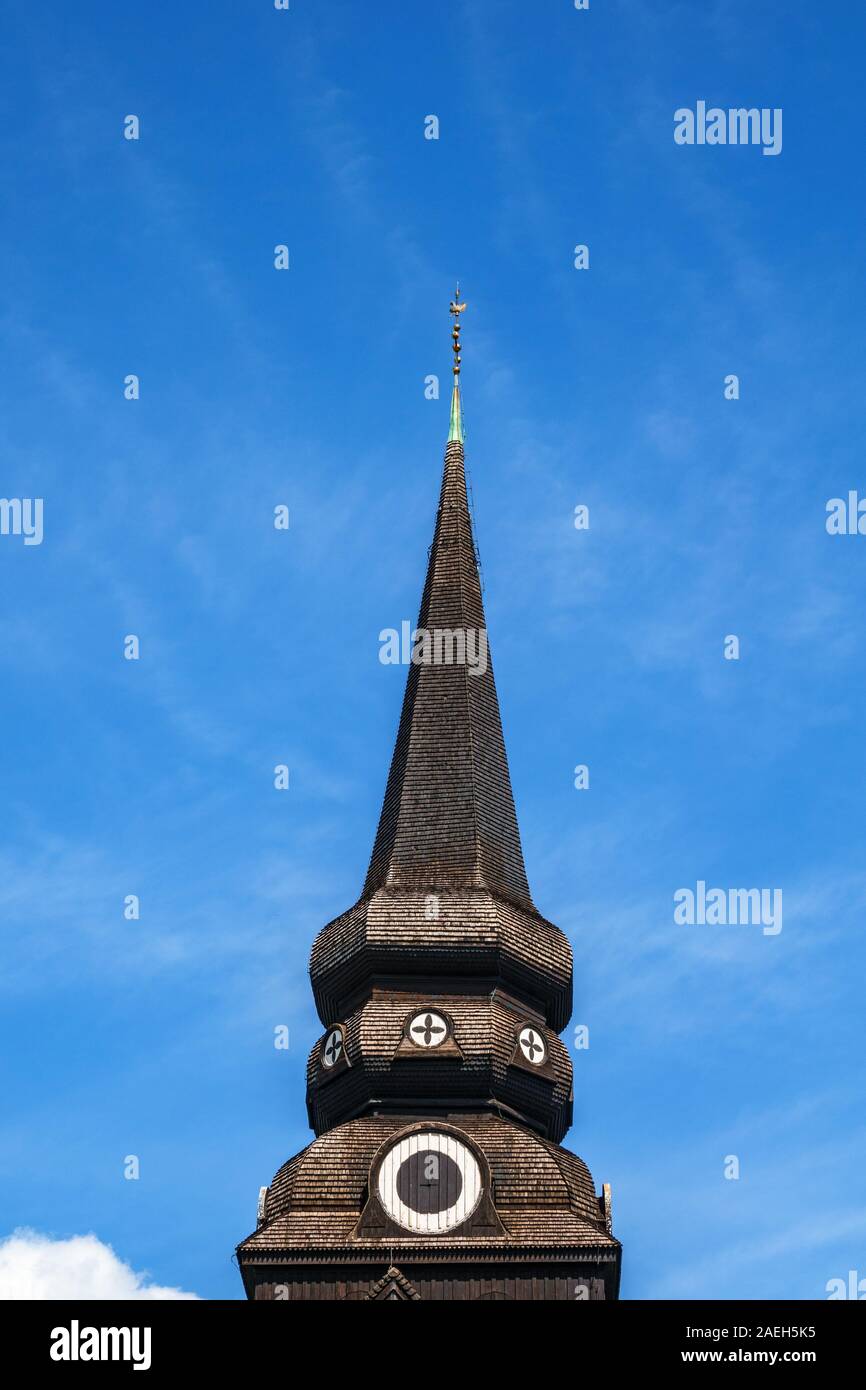 Church spire with black wood shingle at a blue sky Stock Photo