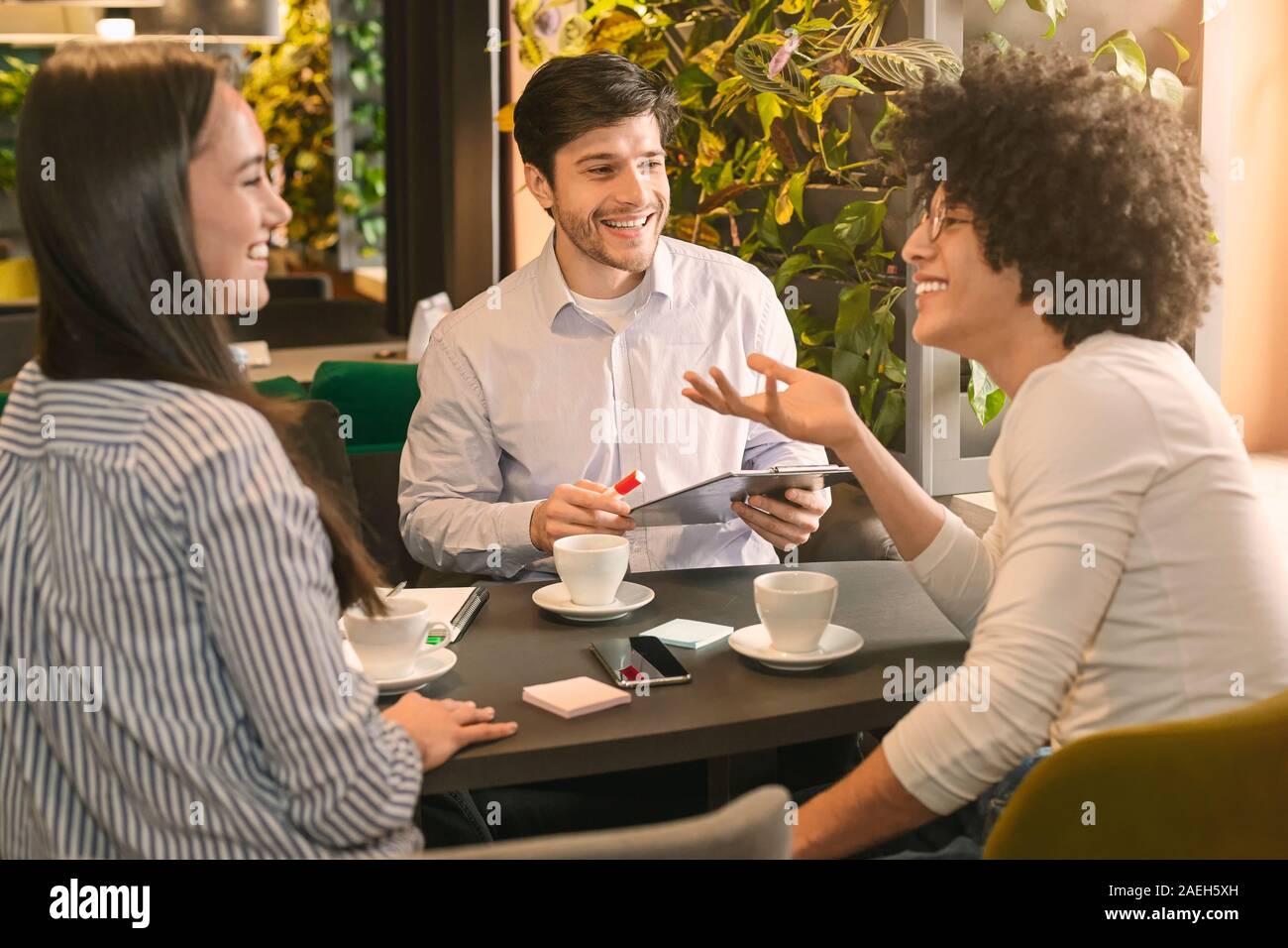Millennial business partners discussing new startup project Stock Photo
