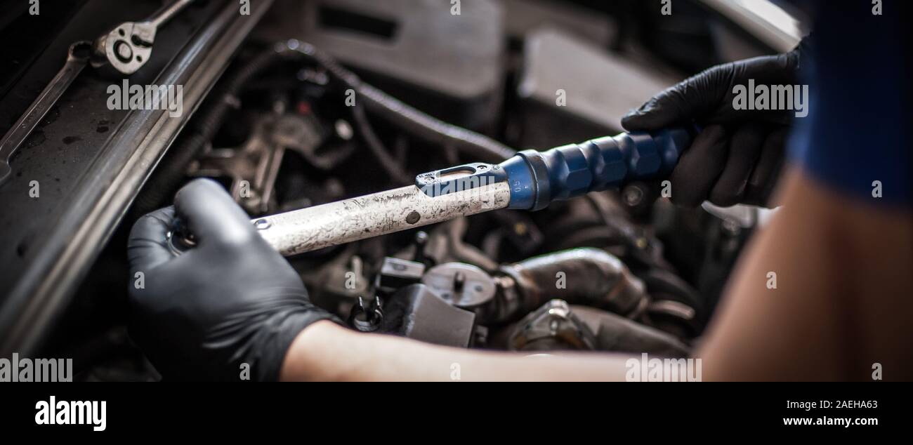 Removing and changing valves. Car mechanic checking automobile valves