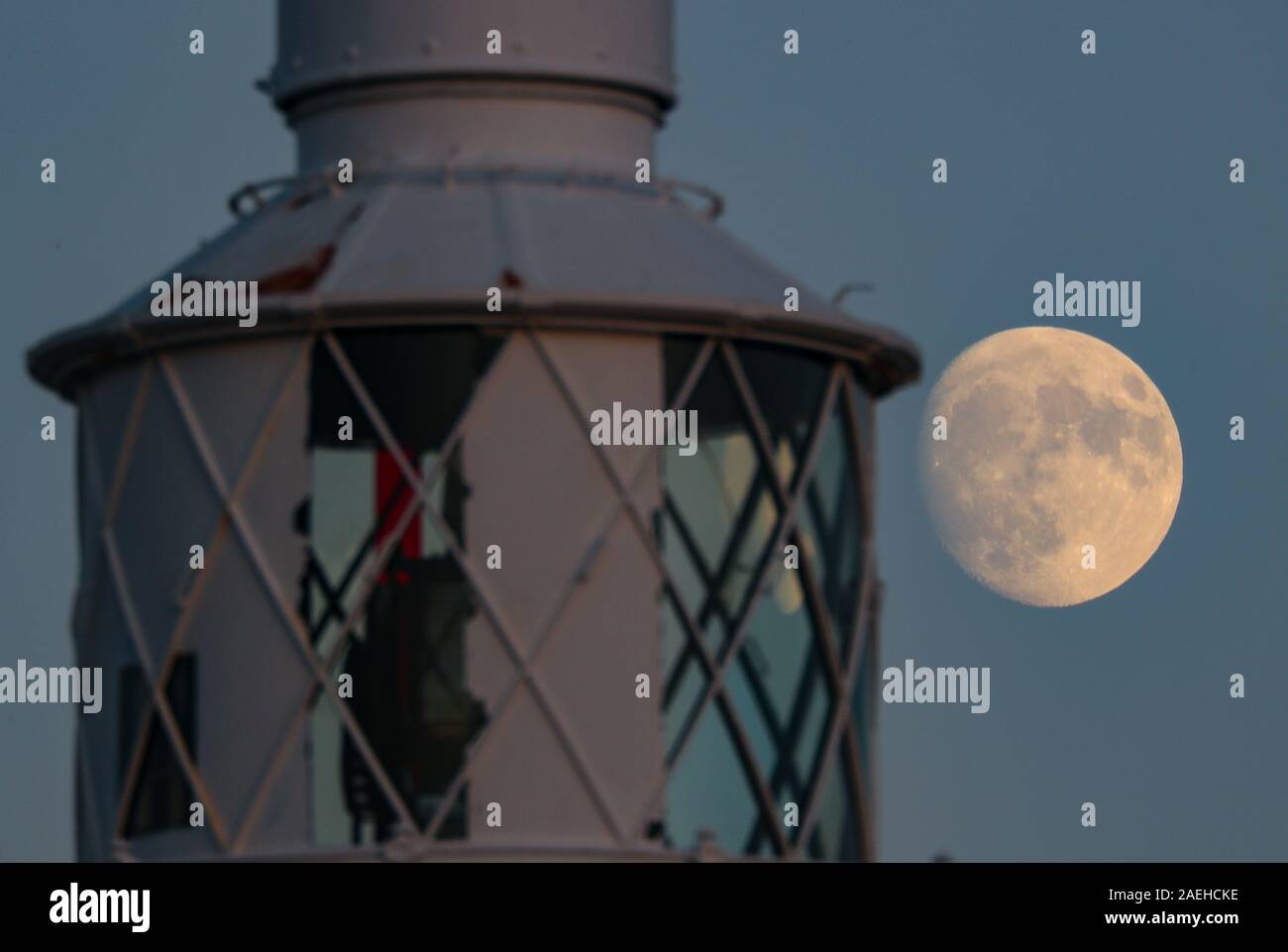 Keyhaven, Hampshire, UK. 9th December 2019, UK Weather: The Waxing Gibbous Moon rises on a clear evening above Hurst Point Lighthouse in Keyhaven, Hampshire ahead of the Full Cold Moon which will appear this Thursday, December 12th at 5.12am GMT. Credit Stuart Martin/Alamy Live News Stock Photo