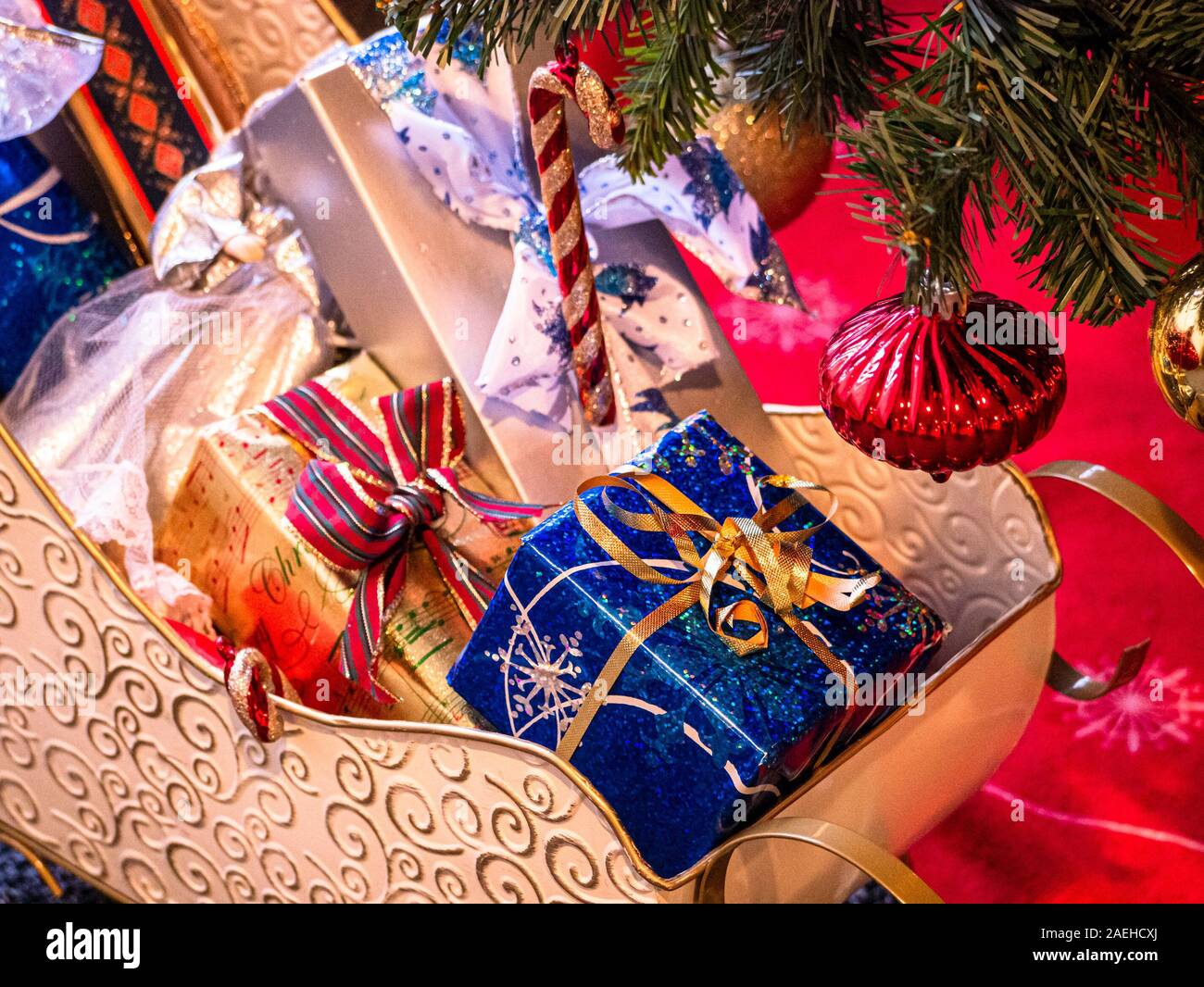 Decorative Santa Claus sleigh with coloured gifts boxes under Christmas ...