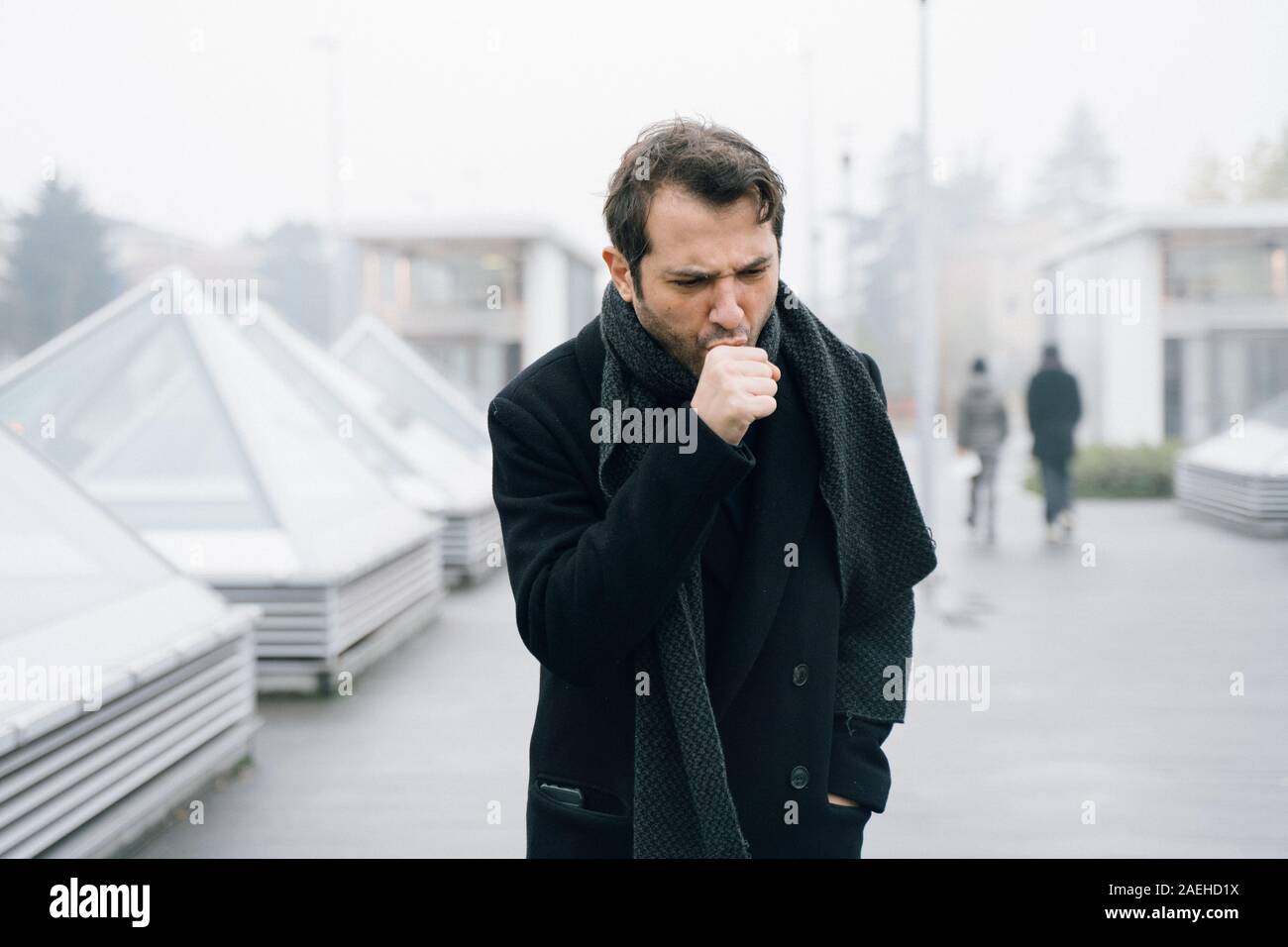 Man coughing and suffering in cold weather Stock Photo
