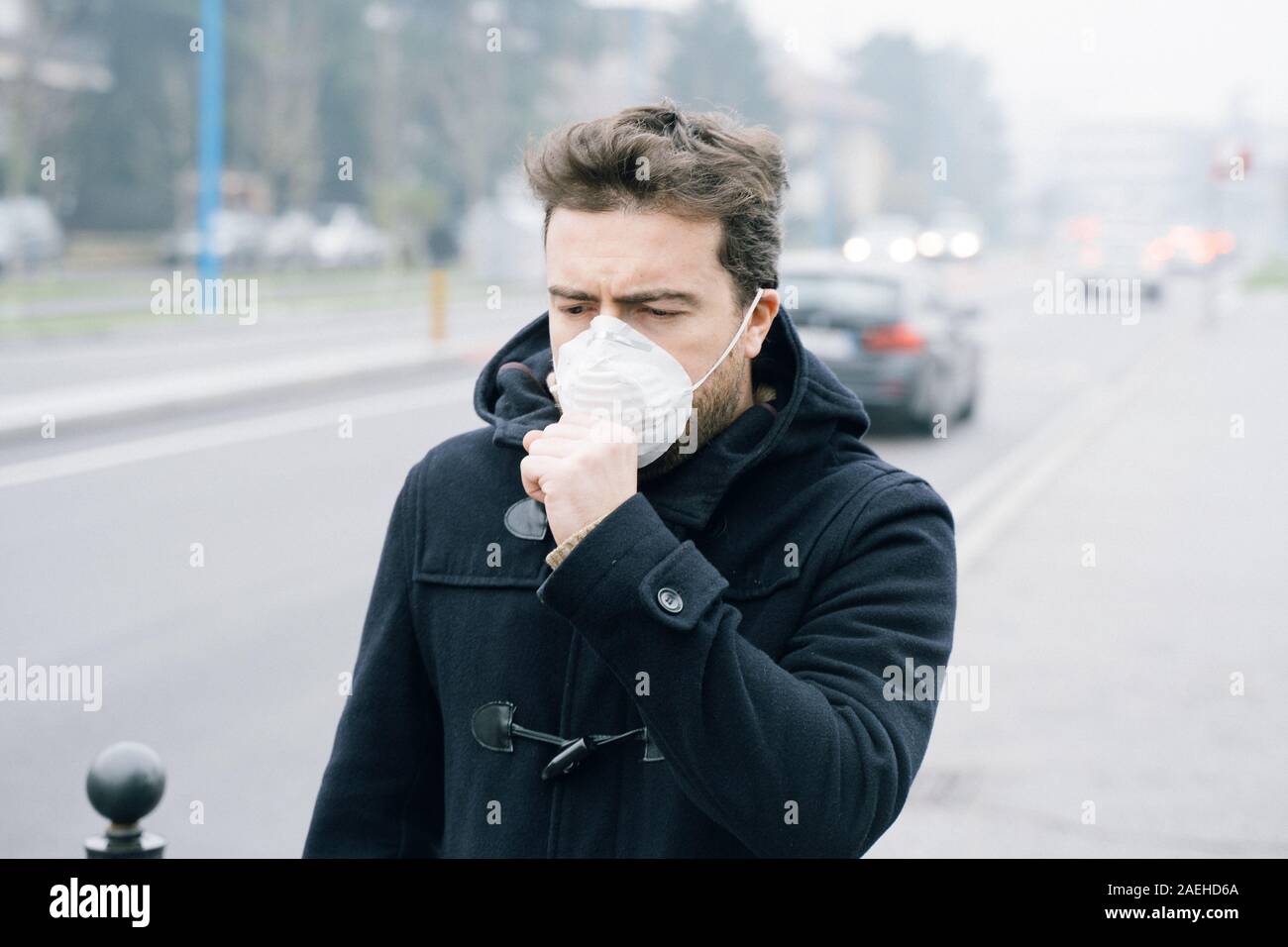 Man wearing protection mask against traffic smog air Stock Photo