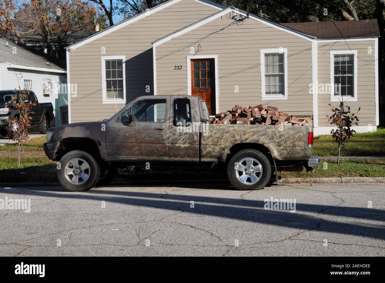 Pickup Truck Loaded with Salvaged House Bricks Parked on Street in