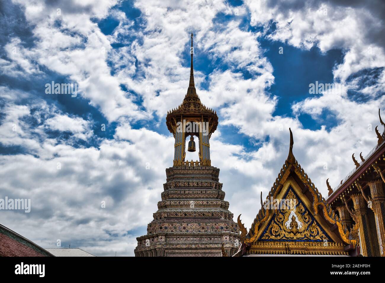 Bangkok, Thailand 11.24.2019: A Thai traditional bell tower (belfry) with detailed, mosaic artwork and gold colored design at Wat Phra Kaew (Temple of Stock Photo