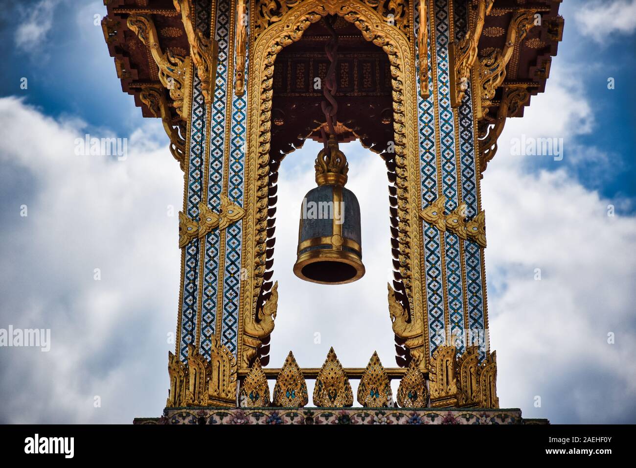 Bangkok, Thailand 11.24.2019: A Thai traditional bell tower (belfry) with detailed, mosaic artwork and gold colored design at Wat Phra Kaew (Temple of Stock Photo