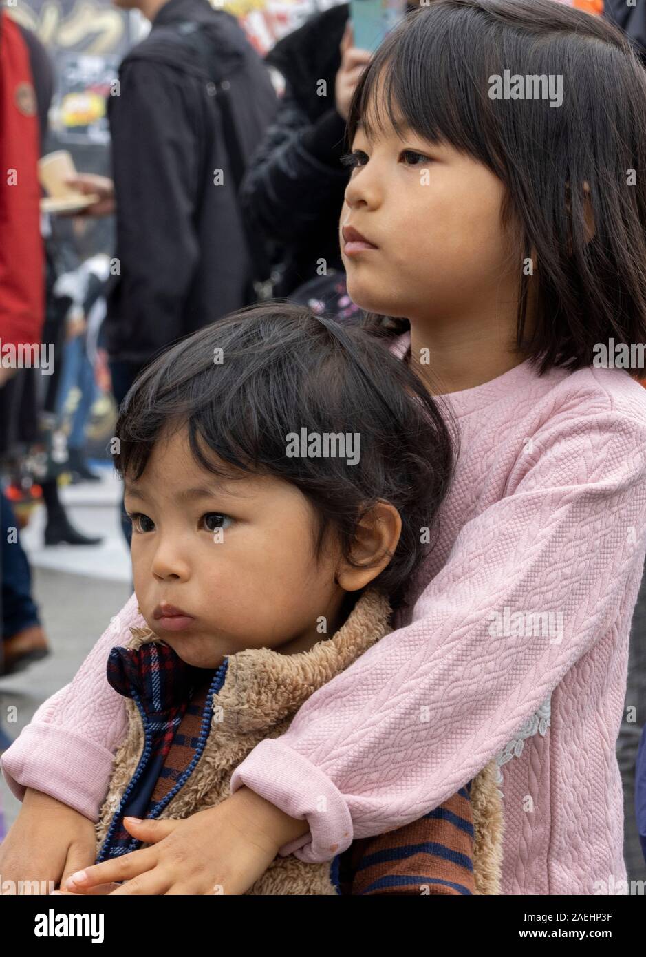 Japanese girl holding her baby brother, Tokyo, Japan Stock Photo
