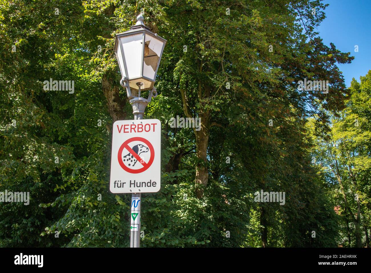Neckargemünd, Germany - August 18, 2019: street lamp in a public park in Germany damaged by vandalism including a sign in German 'Verbot für Hunde' (p Stock Photo