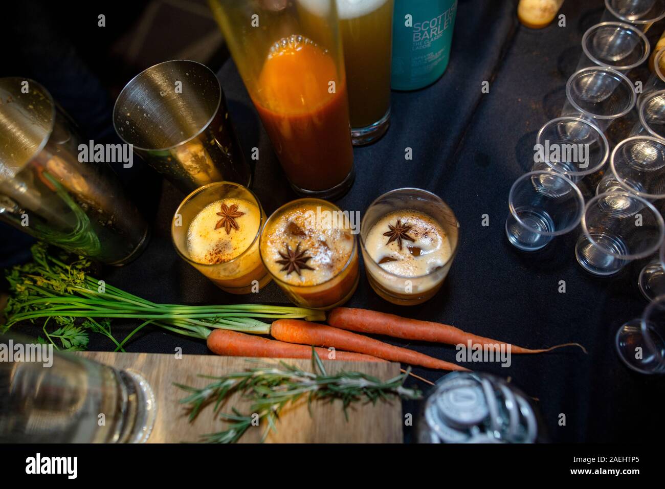 Above view of festive spiced cocktails and glassware on a table Stock Photo