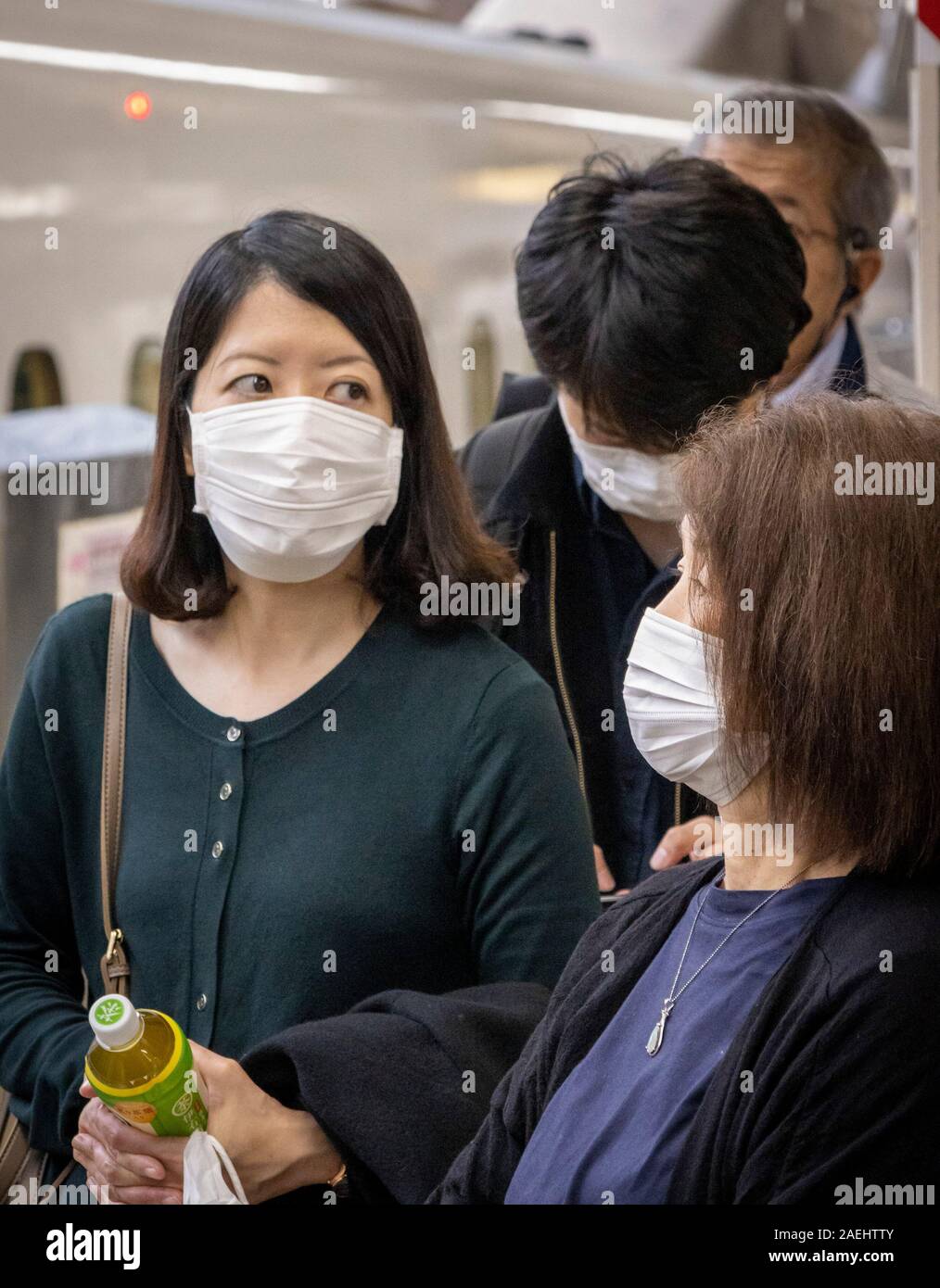 Japanese people wearing surgical masks, Tokyo Station, Tokyo, Japan Stock Photo