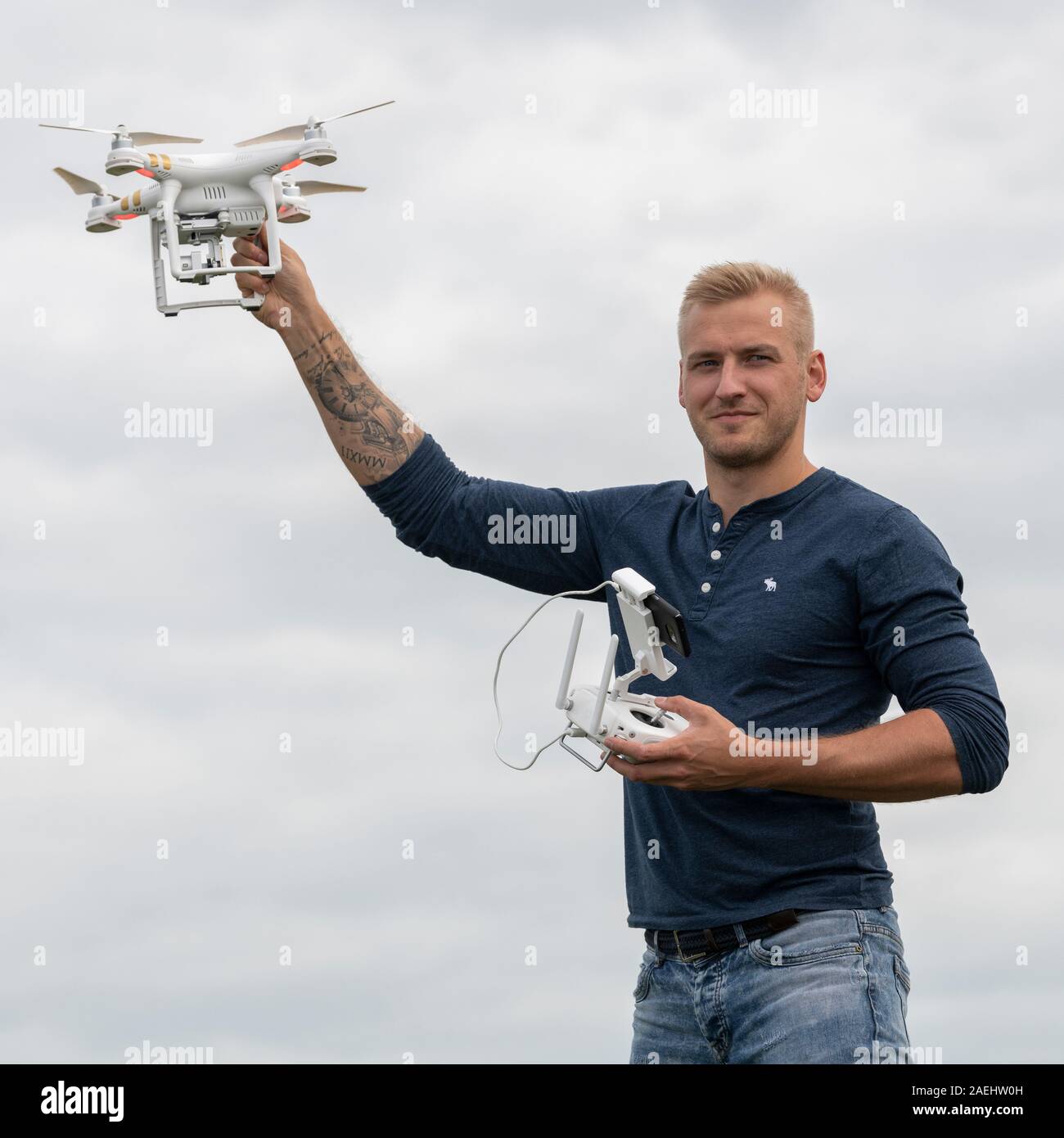 Man holding a drone and remote control, Portrush, The Coastal Route