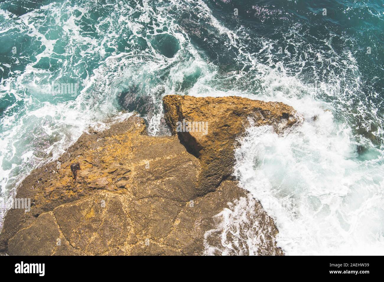 Waves crashing against a rock Stock Photo