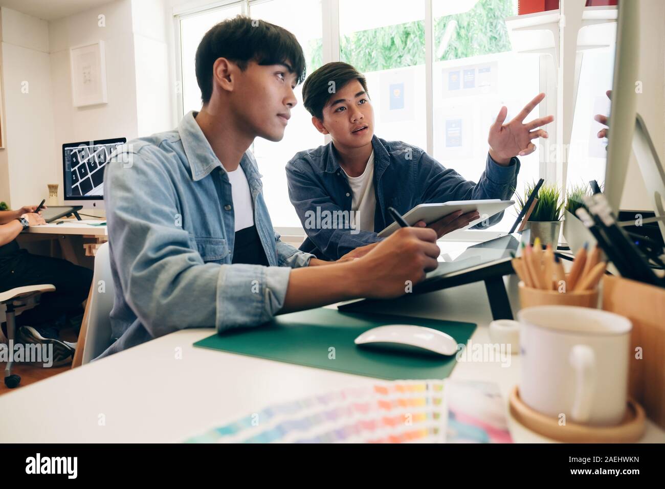 Programmer and UX UI designer working in a software development and coding technologies. Mobile and website design and programing development technolo Stock Photo