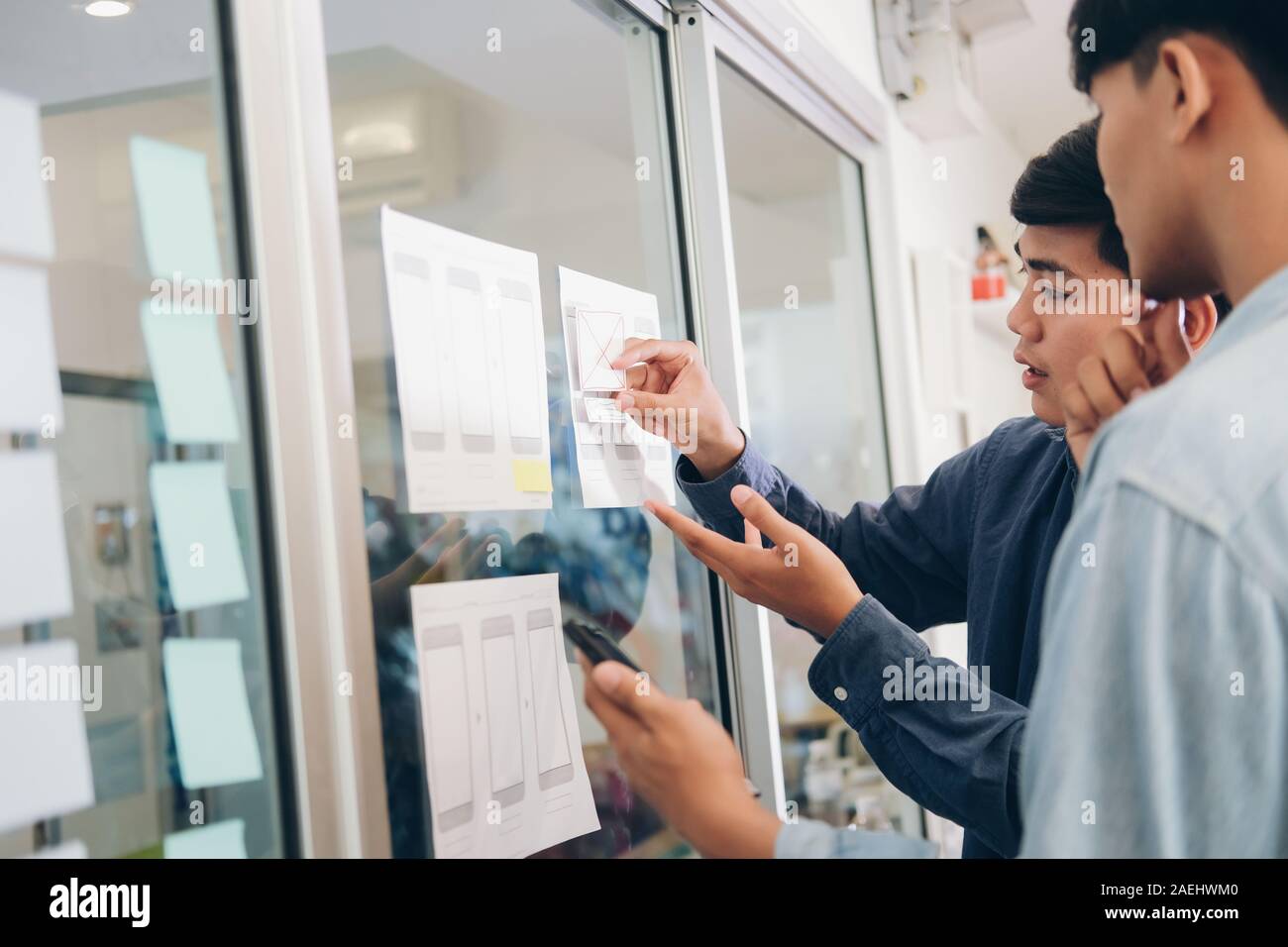 Programmer and UX UI designer working in a software development and coding technologies. Mobile and website design and programing development technolo Stock Photo