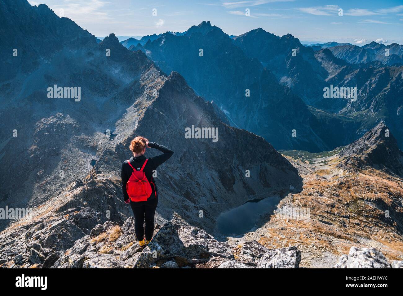 Active life in mountains, Female hiker watching the beautiful scenery in mountains. High Tatras, Slovakia Stock Photo