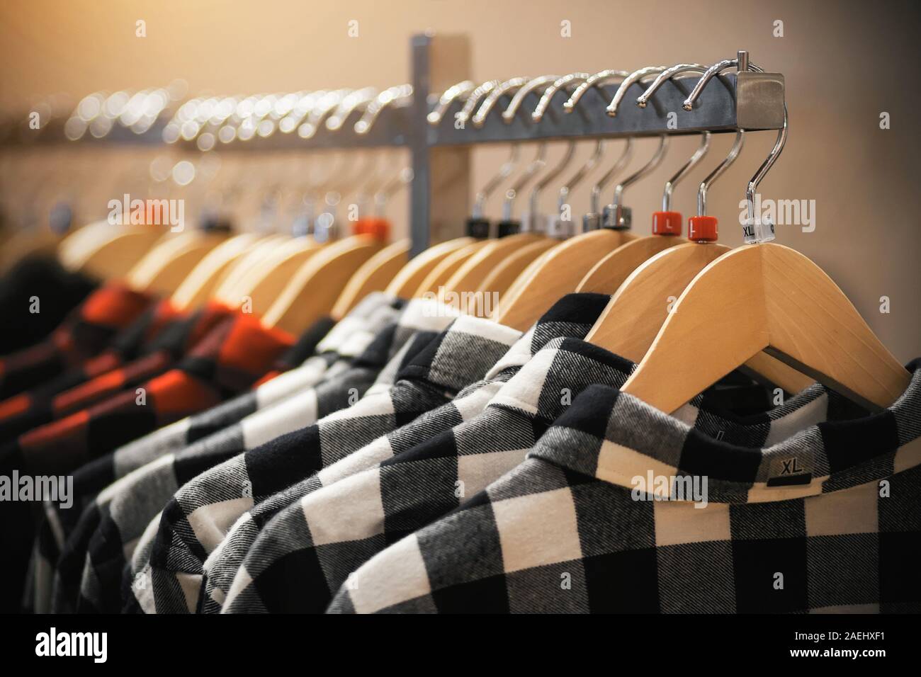 In the clothing store, fashionable youth plaid shirts in red and white