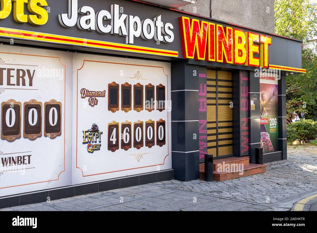 Varna, Bulgaria, December 09, 2019. The front of a Winbet gambling hall entrance. Signage boards above the casinodoor and instead of its windows. Stock Photo