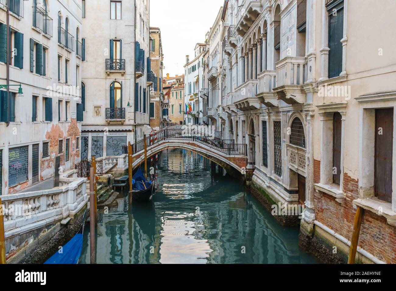 Boats on narrow canal between colorful historic houses in Venice ...