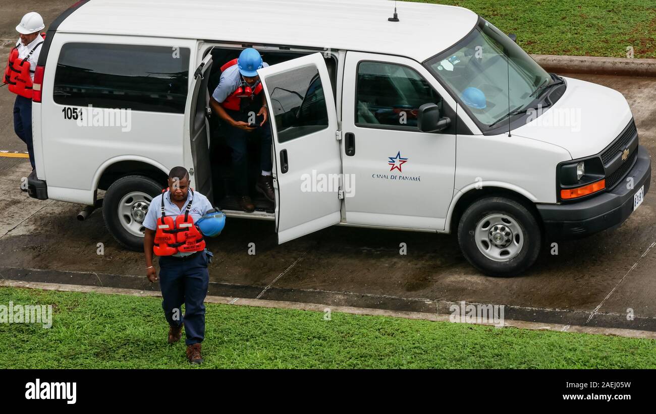 A group of Panama Canal workers leaving the car to start working in Agua Clara Locks Stock Photo