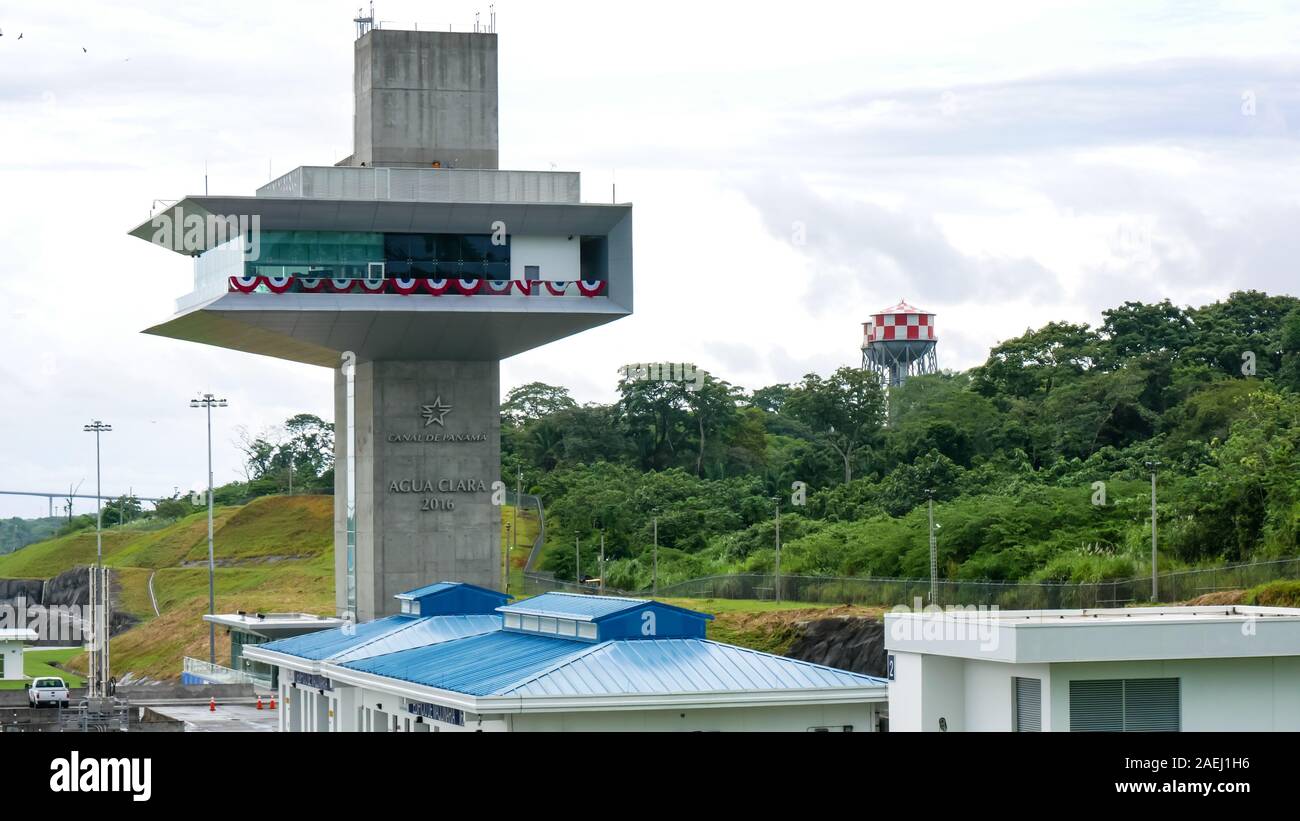 Agua Clara control tower (torre de control). Panama Canal red and white Water towers as background Stock Photo