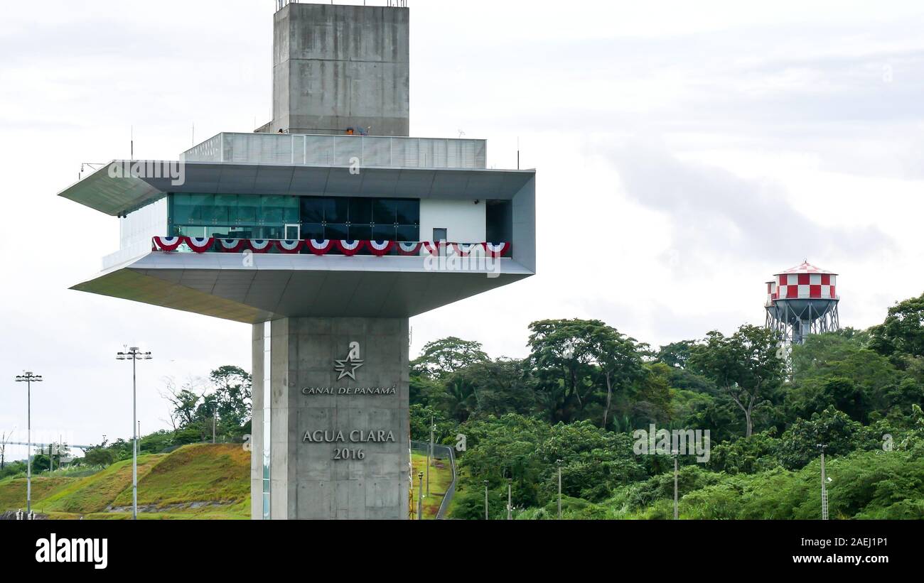 Closeup of Agua Clara control tower (torre de control). Panama Canal red and white Water towers as background Stock Photo
