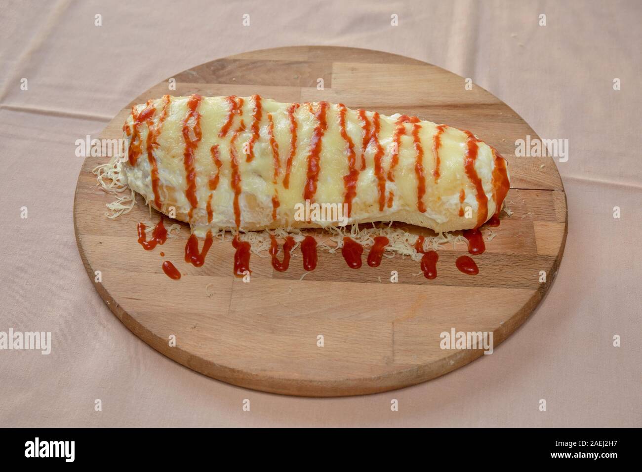 Folded Calzone Italian Cuisine at Wooden Tray Stock Photo - Alamy