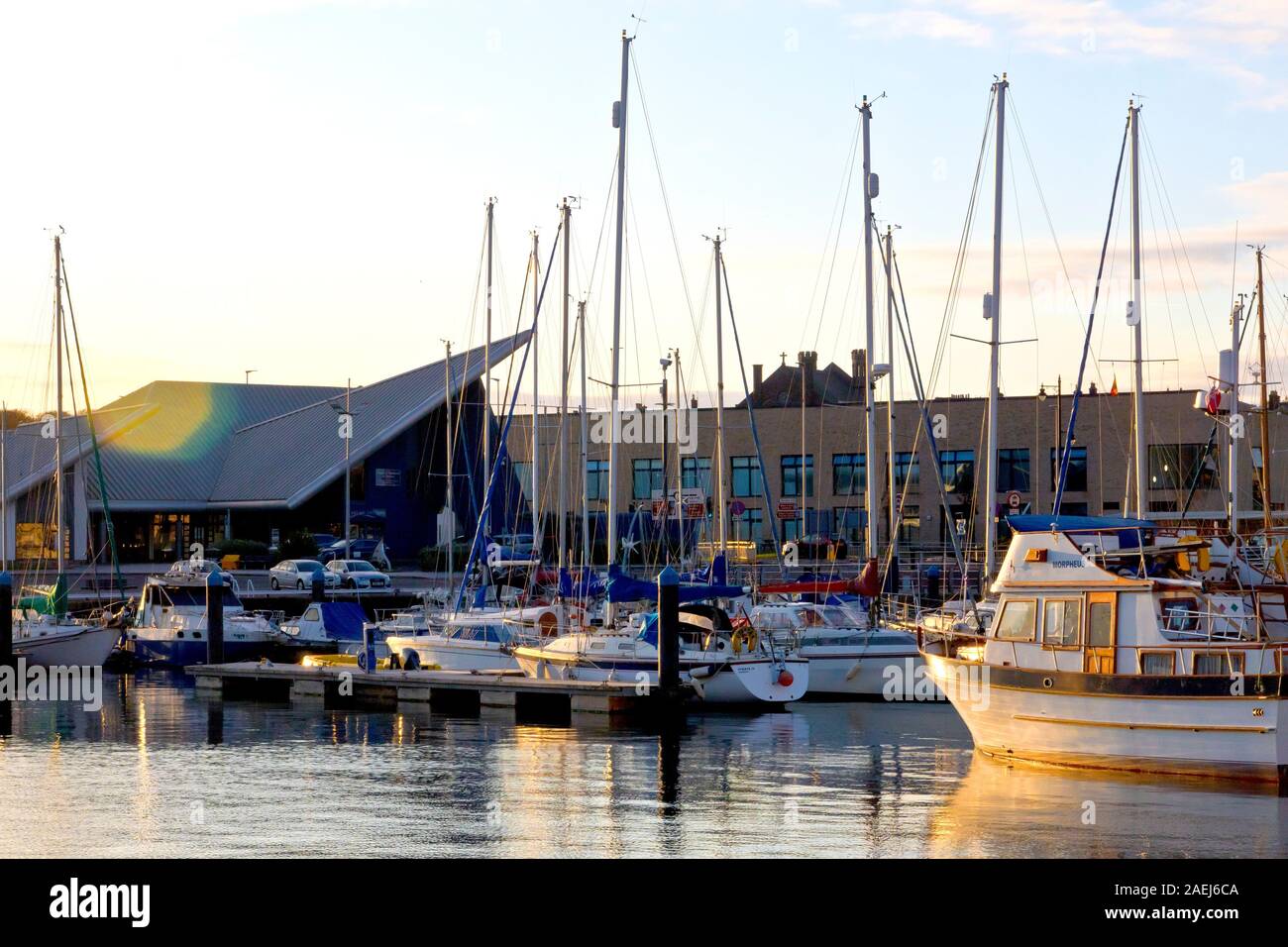 The marina at Arbroath harbour, filled with yachts and pleasure craft, lit by the warm directional light of a low sun at the end of the day. Stock Photo