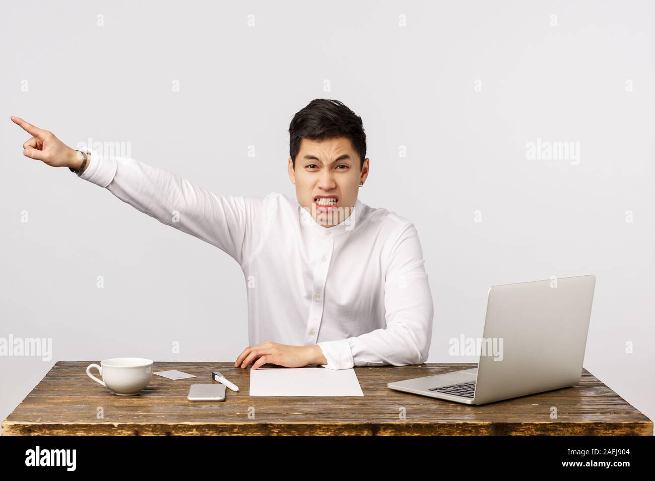 Get out of my office, go. Angry, aggressive and outraged asian male boss  demand leave, pointing at exit and shouting bothered, frowning looking  Stock Photo - Alamy