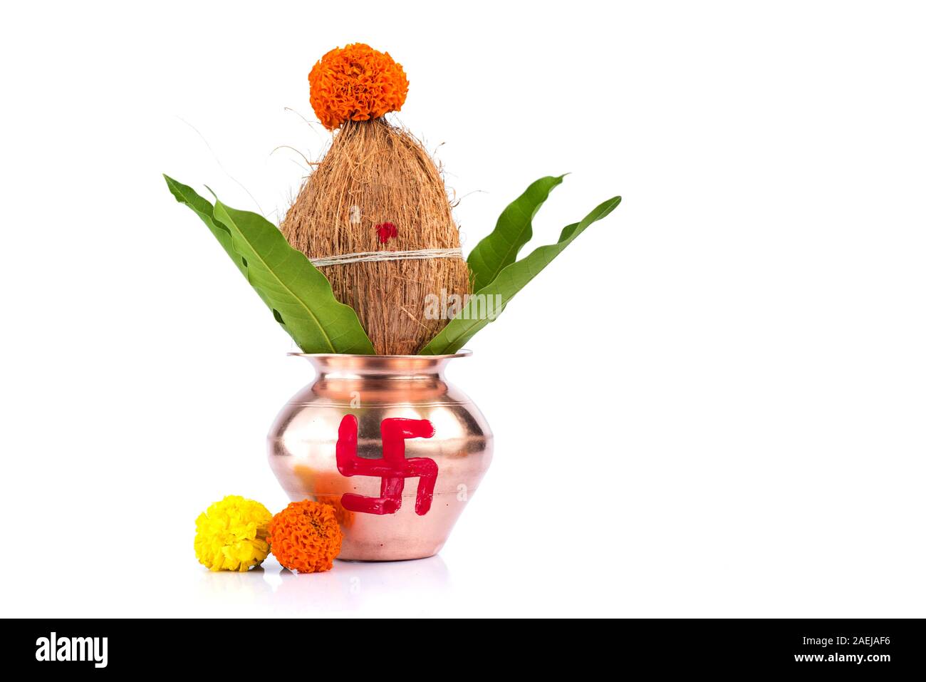 Copper Kalash with coconut and mango leaf with floral decoration on a