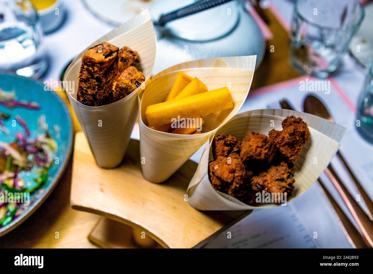 Selection of fritters in cones at Lahpet, Shoreditch, London, UK Stock Photo