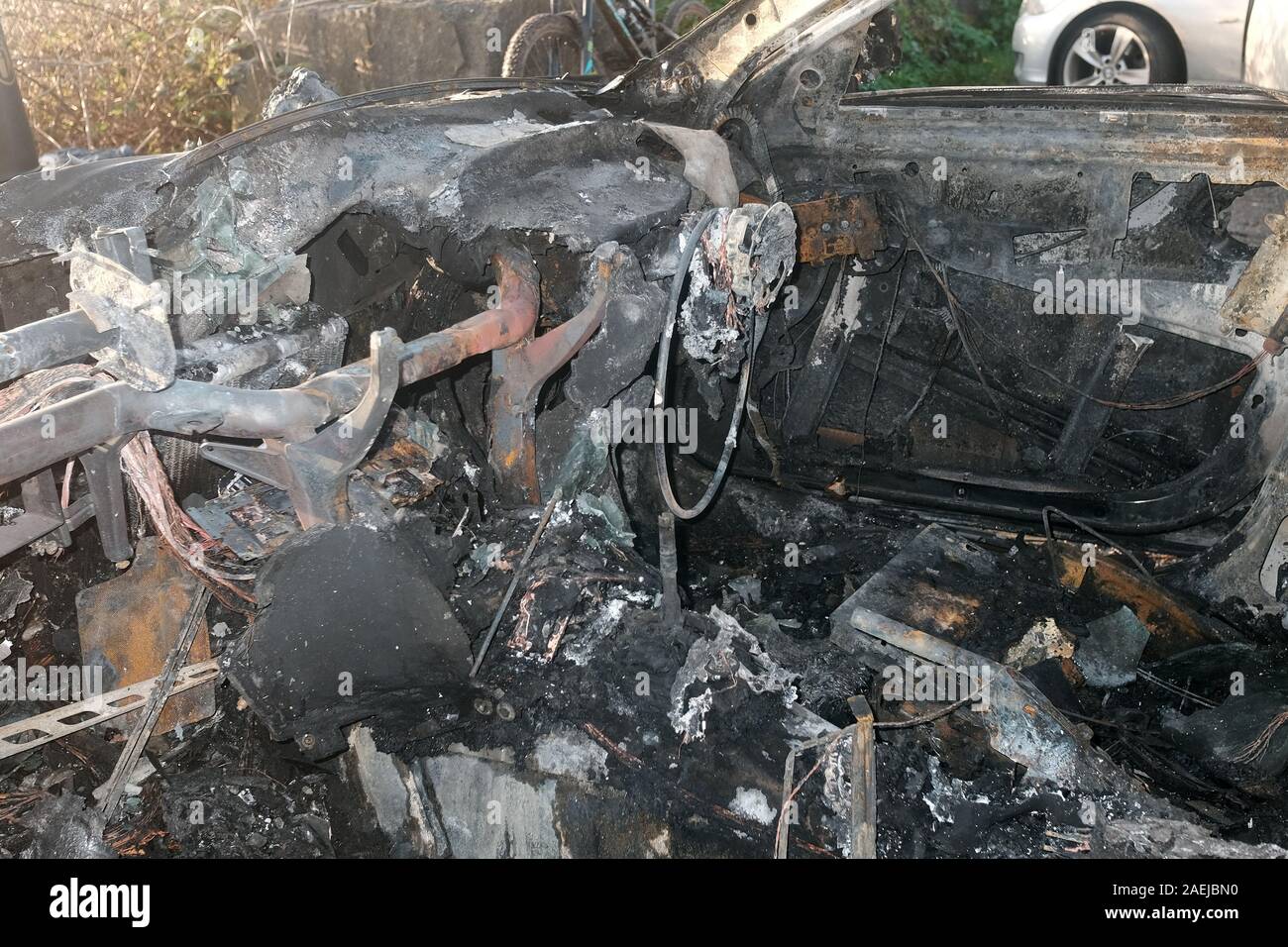 December 2019 - Burnt out stolen BMW estate car which had been deliberately set on fire to destroy evidence. Stock Photo