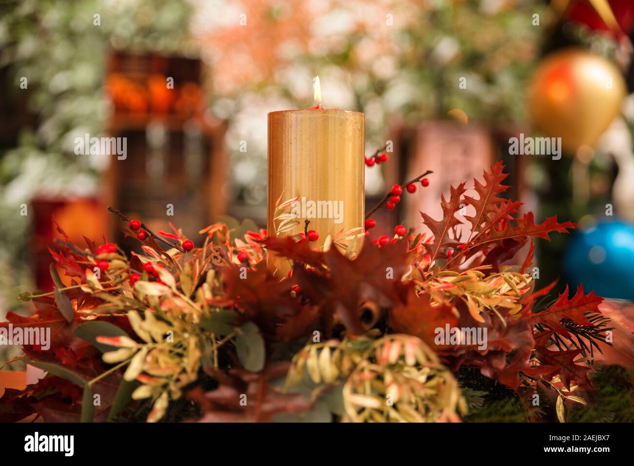 warm background with a lighted candle and christmas decorations Stock Photo
