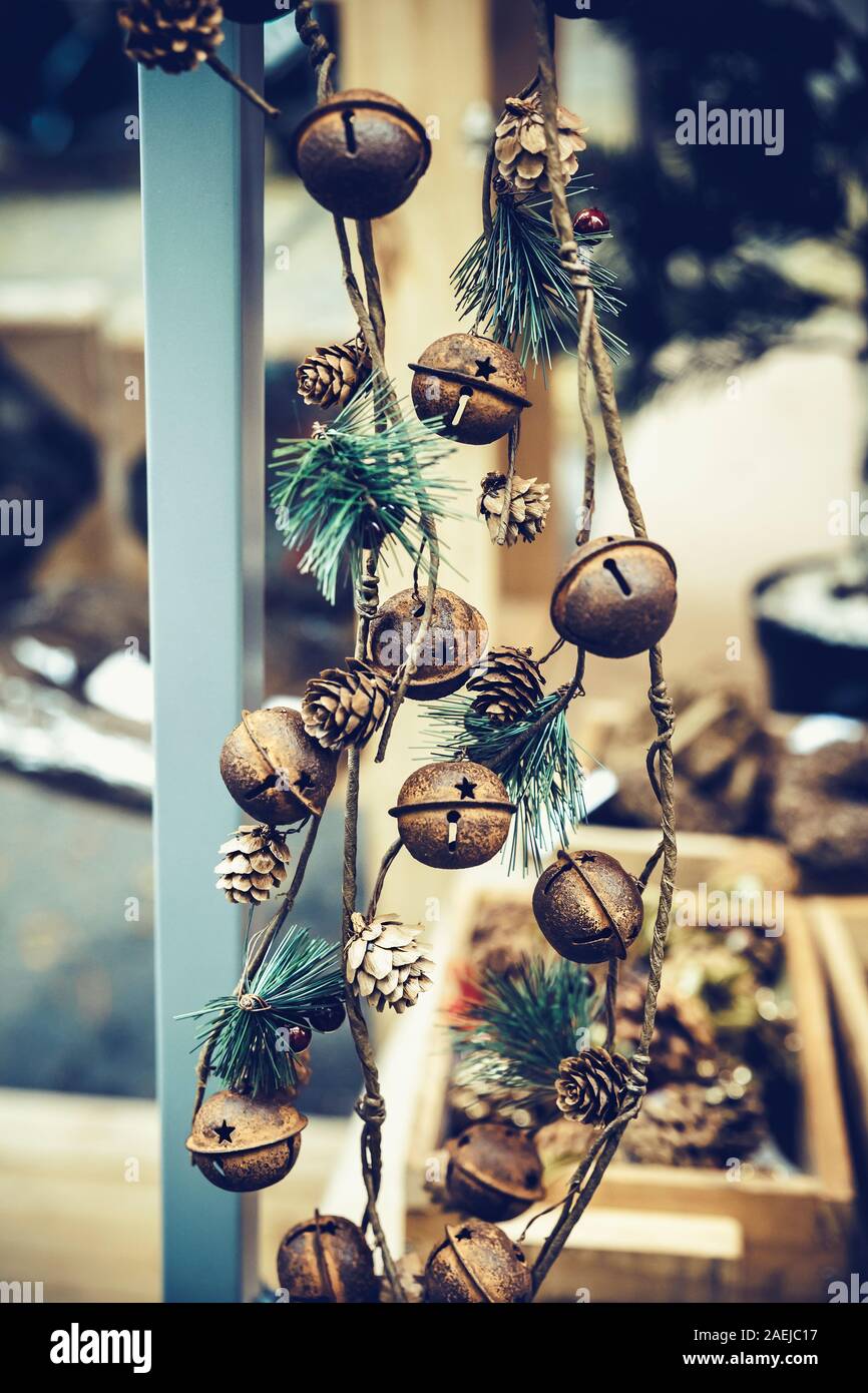 background of small brown bells and pine cones hanging from a pole Stock Photo