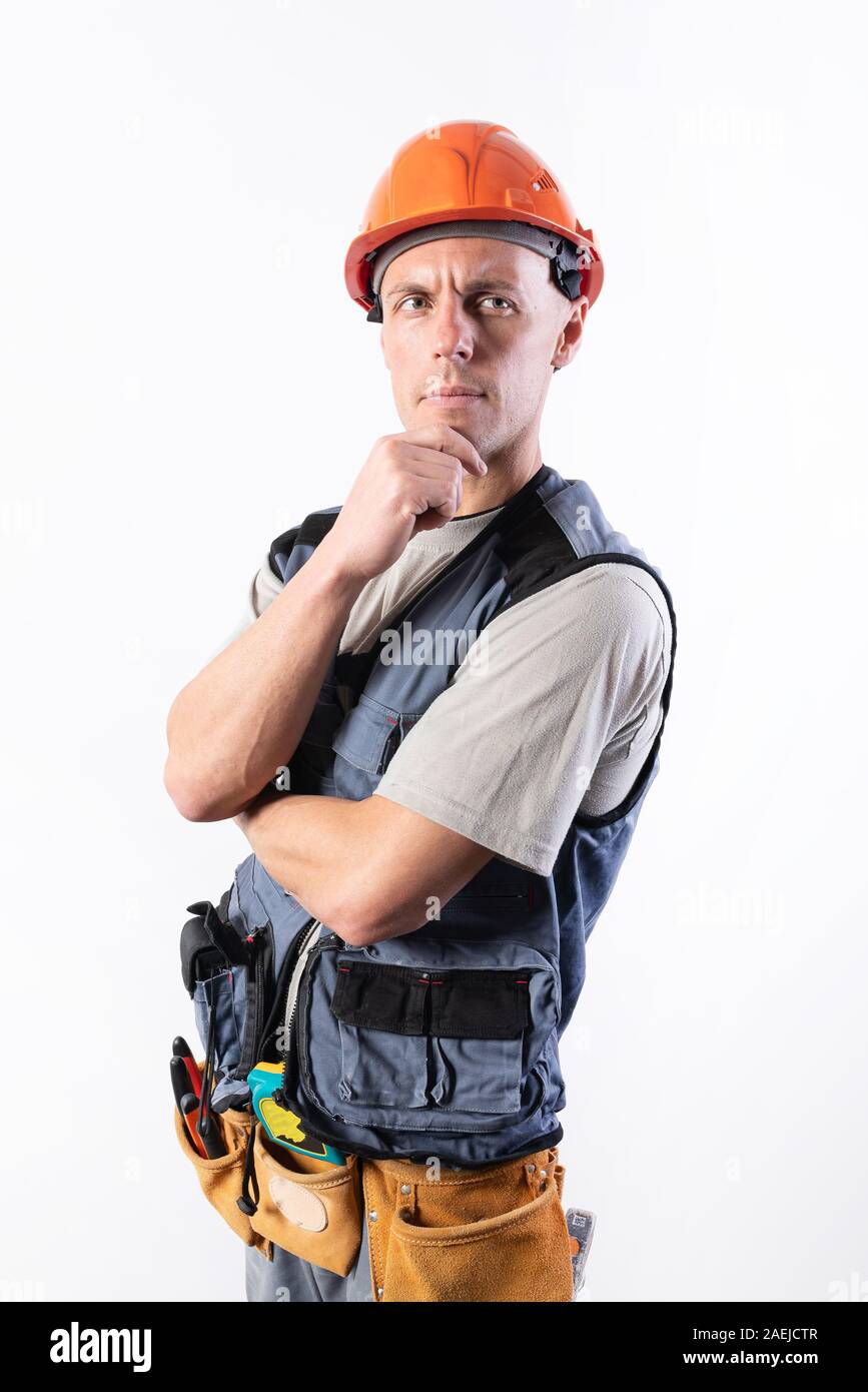 The builder thought. In work clothes and hard hat. Stock Photo